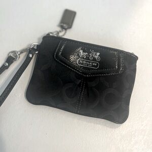 Coach Wristlet. Black Logo Print with Satin Purple interior.